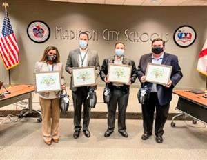 board members holding framed pictures of the tree 